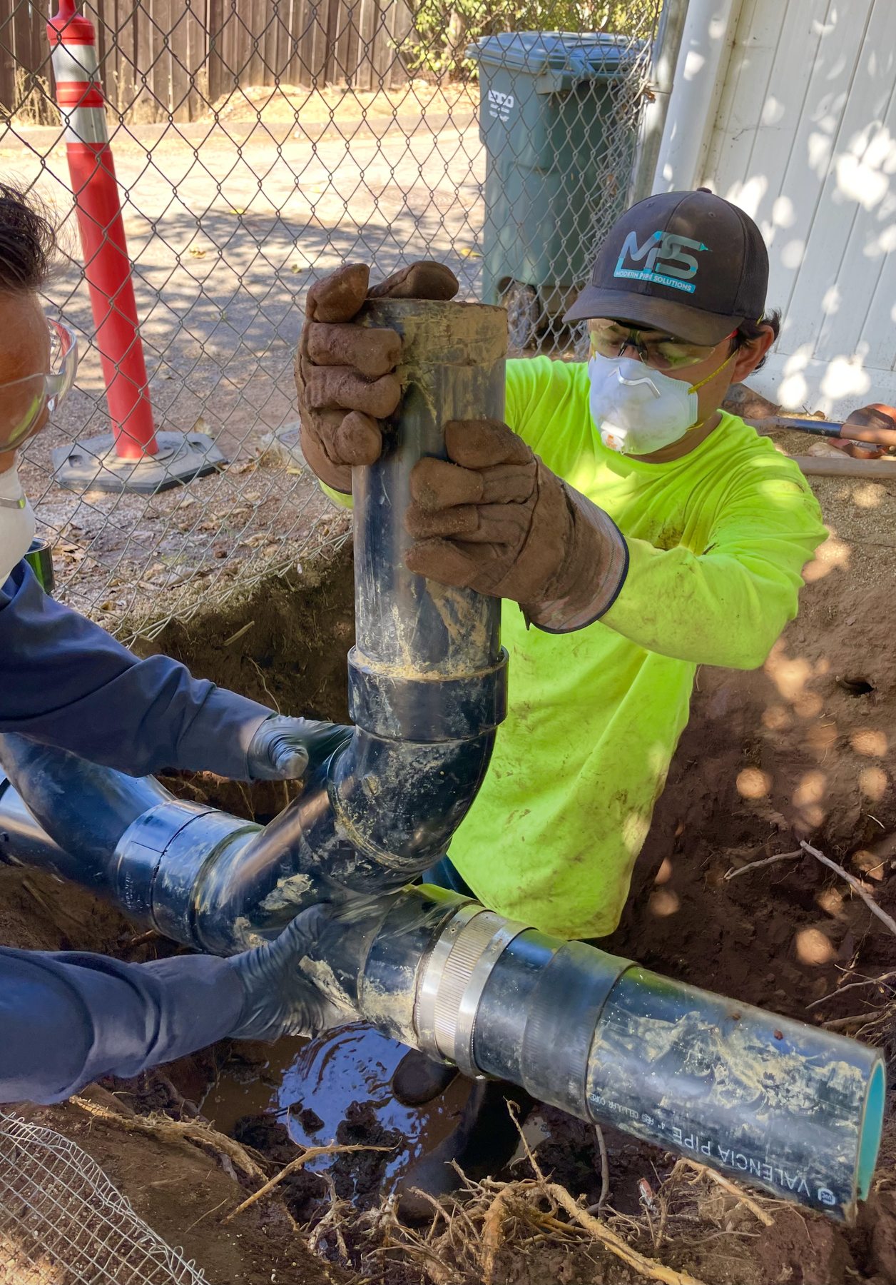 Crew repairing an underground pipe